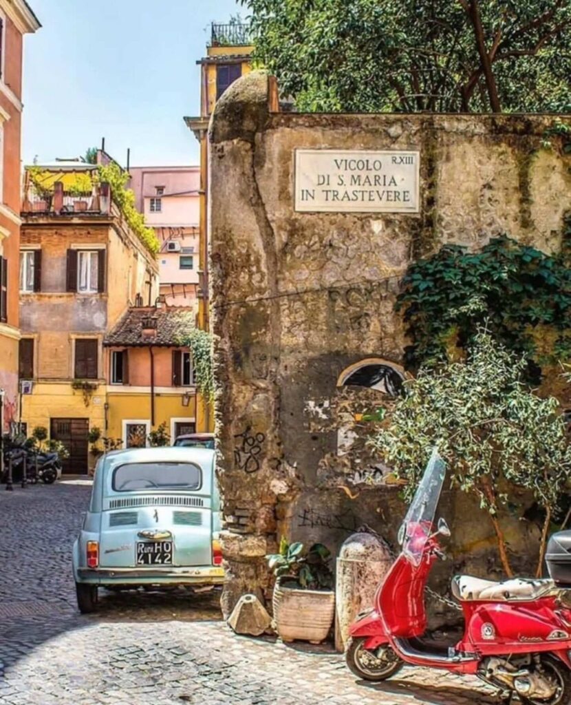 Charming street in Trastevere lined with scooters and cafes