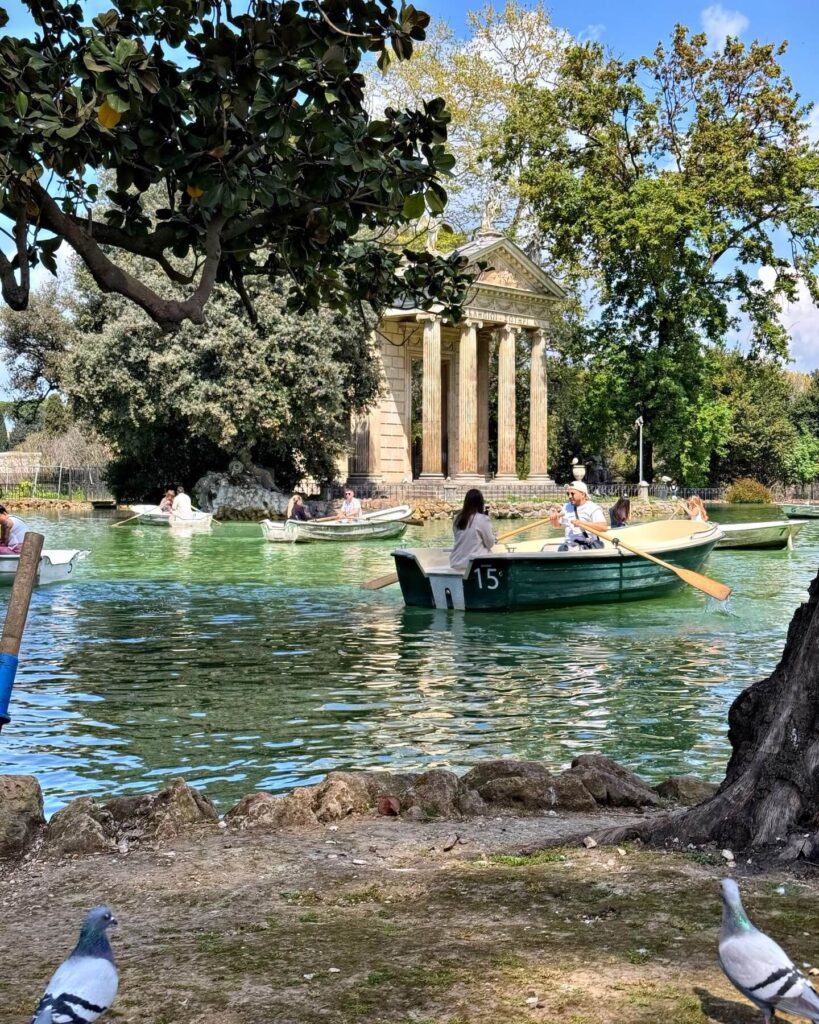 Pathway through Villa Borghese park with sunlight and trees