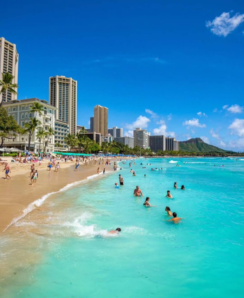 Surfers riding small waves at Waikiki Beach