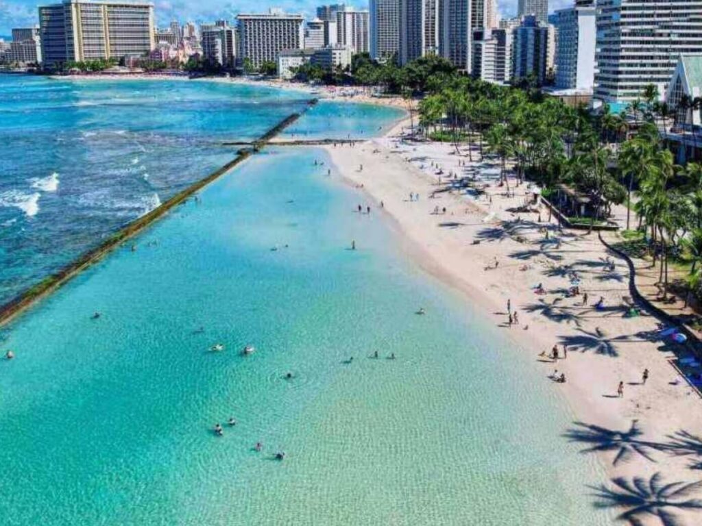 Waikiki Beach in Oahu with Diamond Head in the background and surfers in the water
