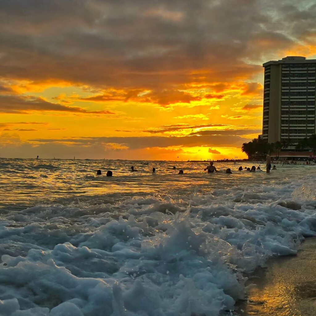 Visitors arriving early at Waikiki Beach to enjoy golden hour before sunset
