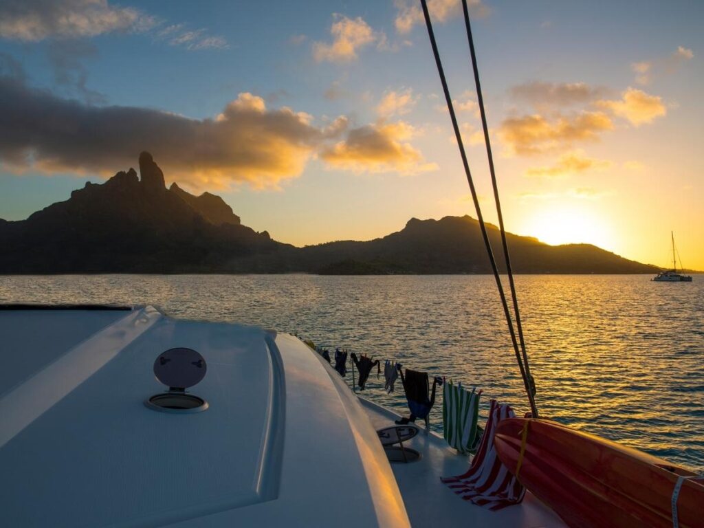 Catamaran sailing off Waikiki Beach during a colorful Hawaiian sunset
