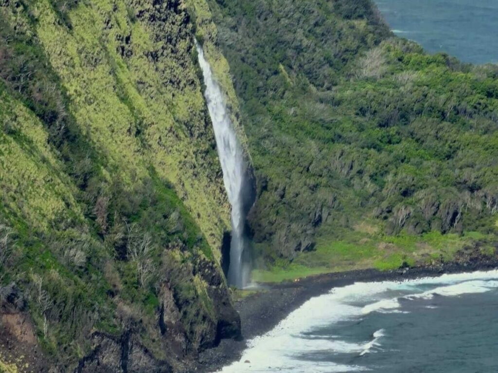 Waterfalls cascading down cliffs in Waipio Valley on the Big Island