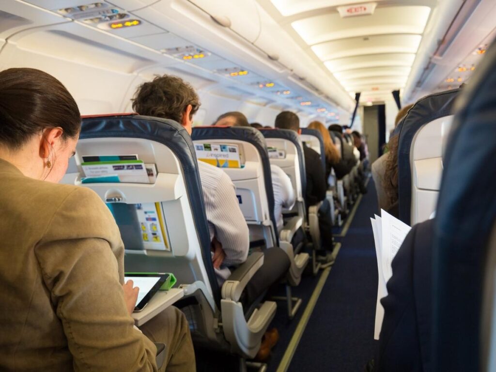 Traveler choosing an aisle seat on an airplane.