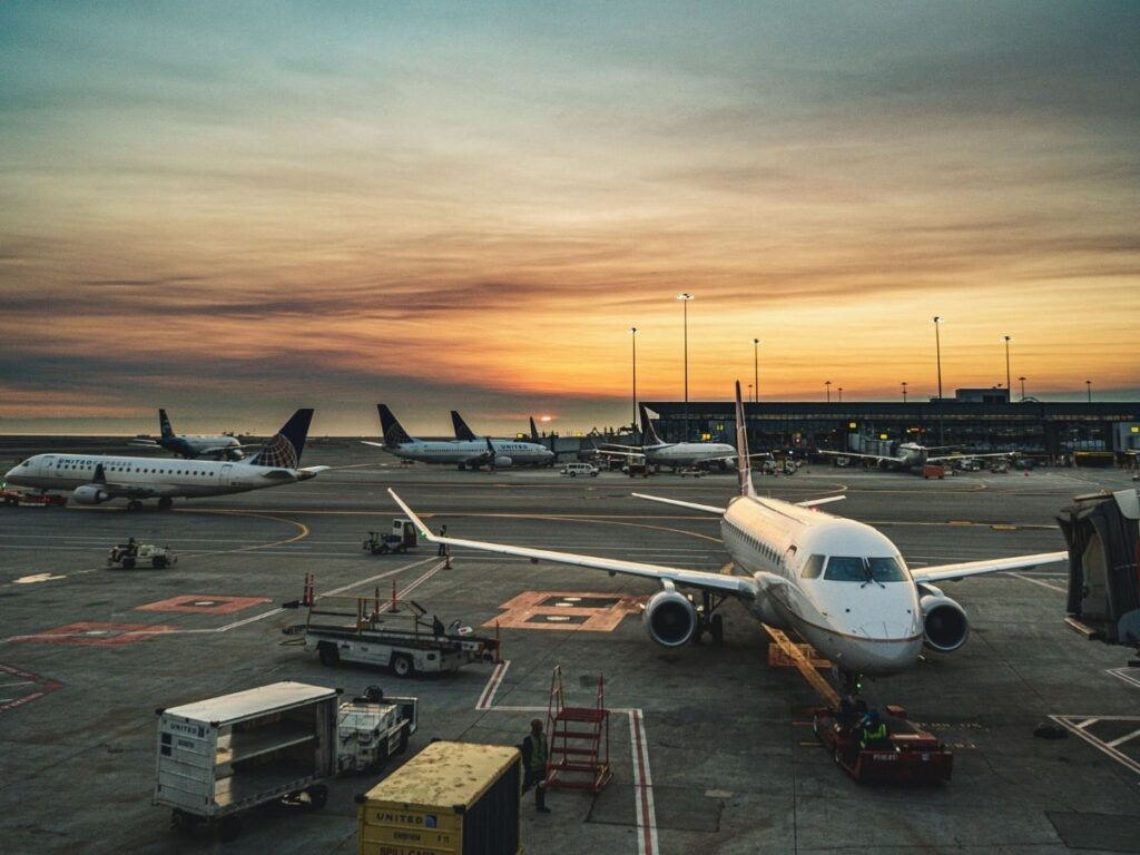Airplane taxiing before takeoff during golden hour at airport