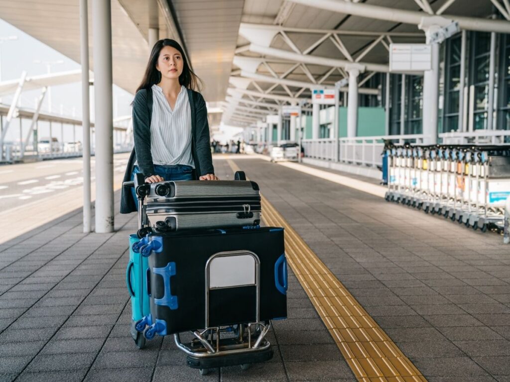 Woman standing outside terminal looking for ride