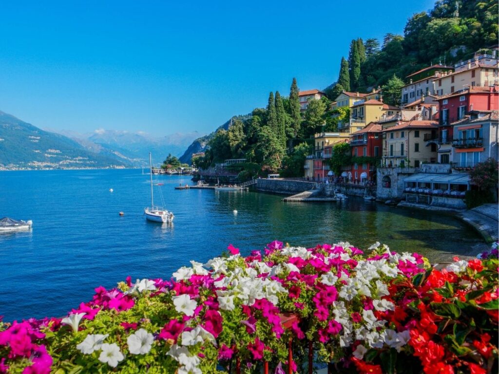 Flower-lined promenade in Bellagio, Italy with views of Lake Como