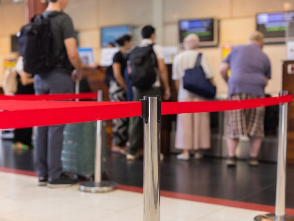 Travelers lining up at a gate for priority boarding on a budget airline flight.