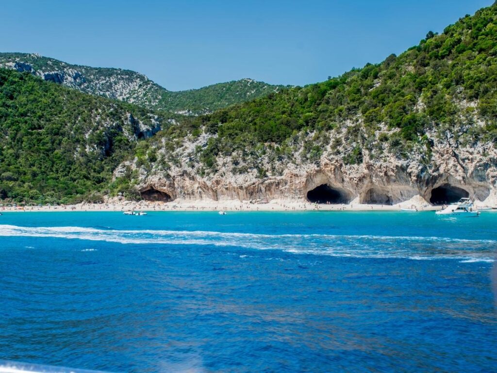Secluded Cala Luna beach with caves and turquoise waters in Gulf of Orosei, Sardinia
