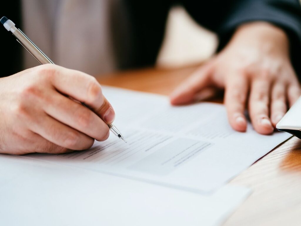 Person filling out customs form at airport
