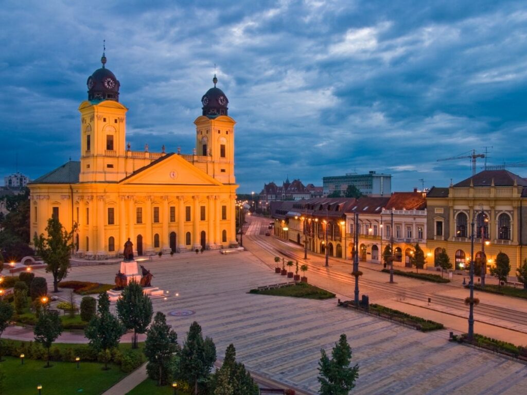 Main square in Debrecen with historic buildings and tram tracks