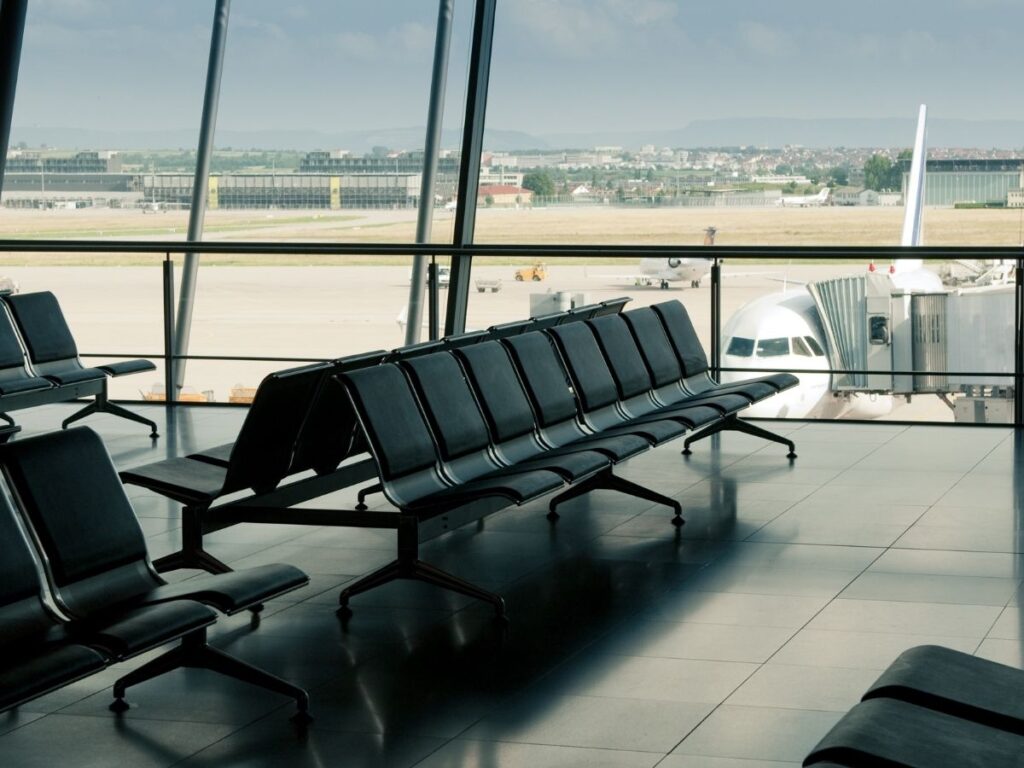 Quiet airport terminal with empty seats during a weekday morning