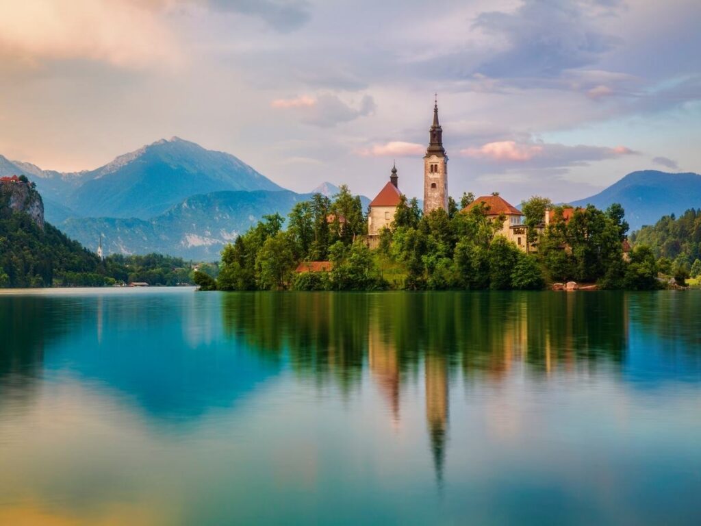 Lake Bled with island church and surrounding mountains in Slovenia