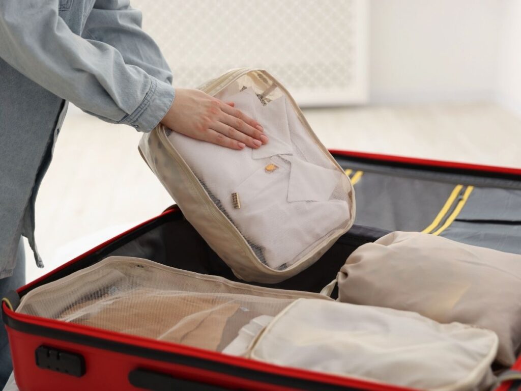 Small packing cube with neatly folded clothing and toiletries