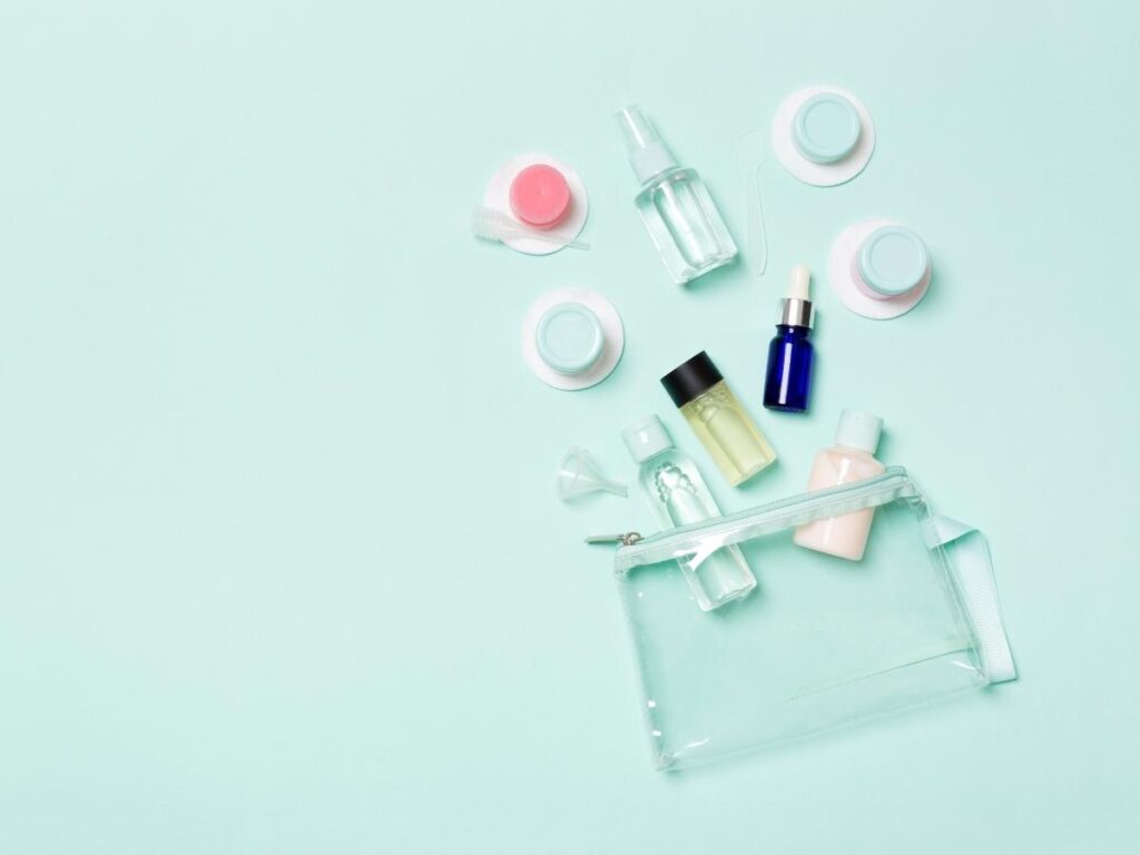 Compact toiletries pouch with essentials like sunscreen and moisturizer, packed French style.