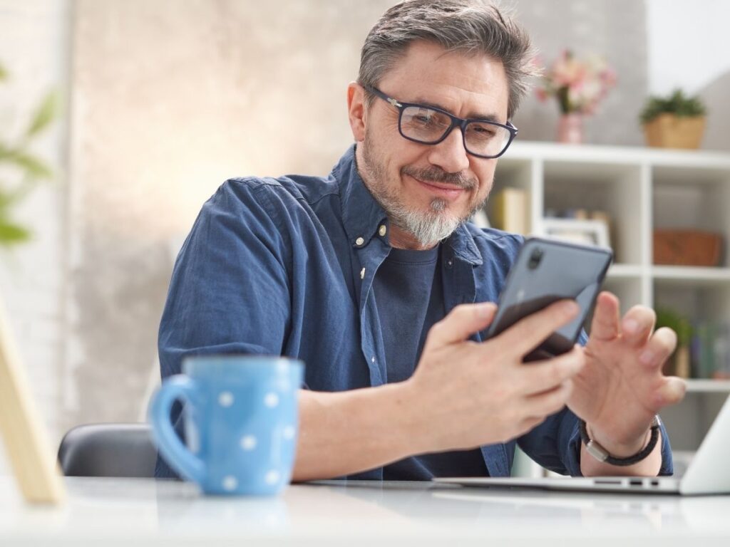Traveler doing online flight check-in on laptop with coffee nearby	