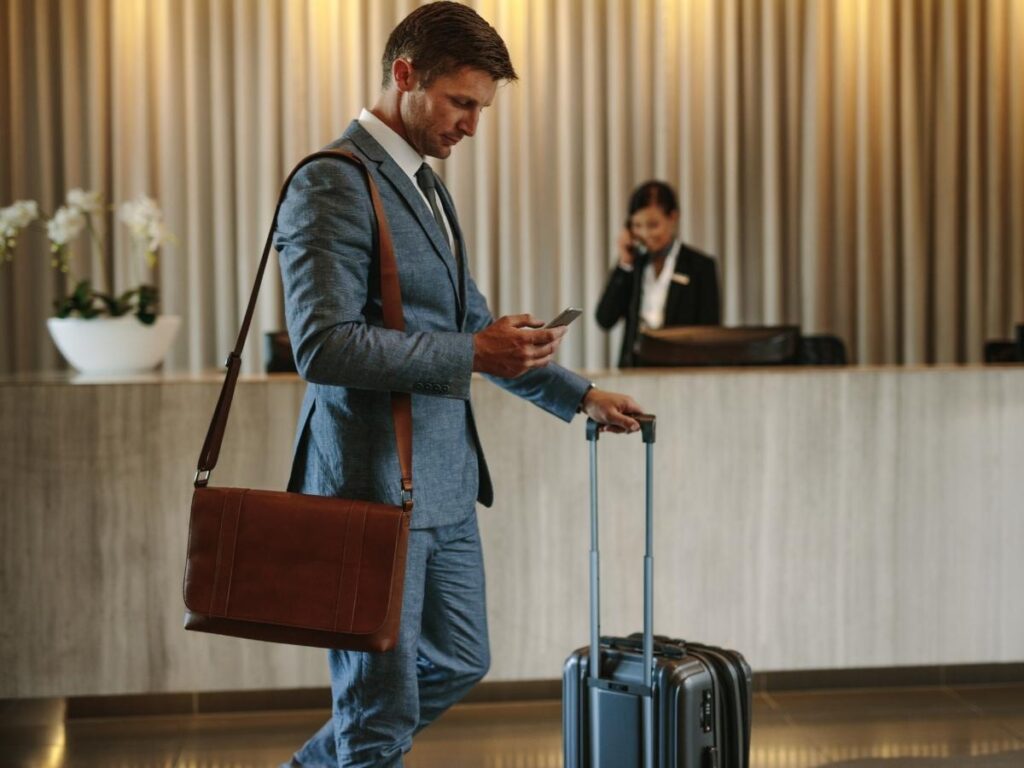 Traveler scrolling through Airbnb and hotel reviews on a smartphone.