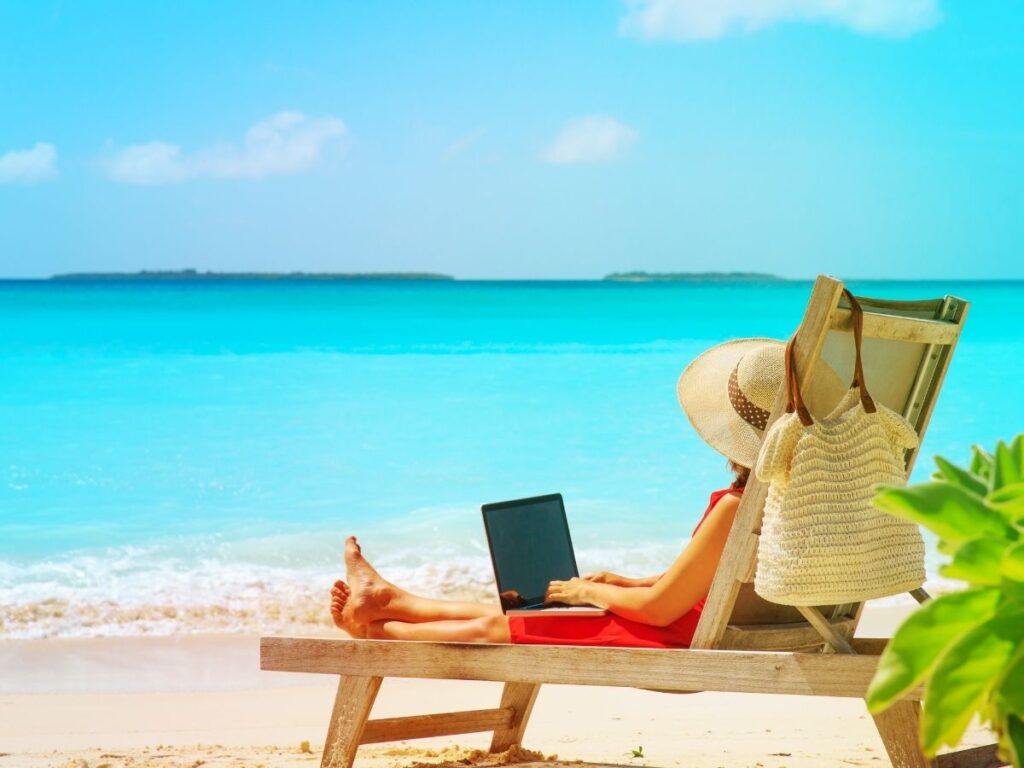Woman working remotely on a laptop with a scenic nature backdrop