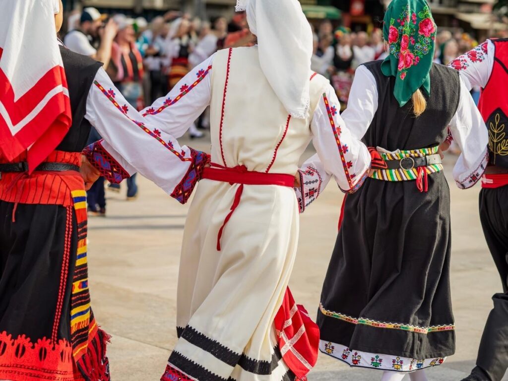 Slovak villagers dancing in a small town square during a harvest festival.