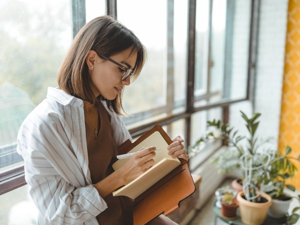 Solo traveler journaling at a café while exploring a new city
