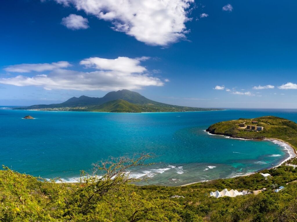 Aerial view of St. Kitts and Nevis coastline with green hills and turquoise water