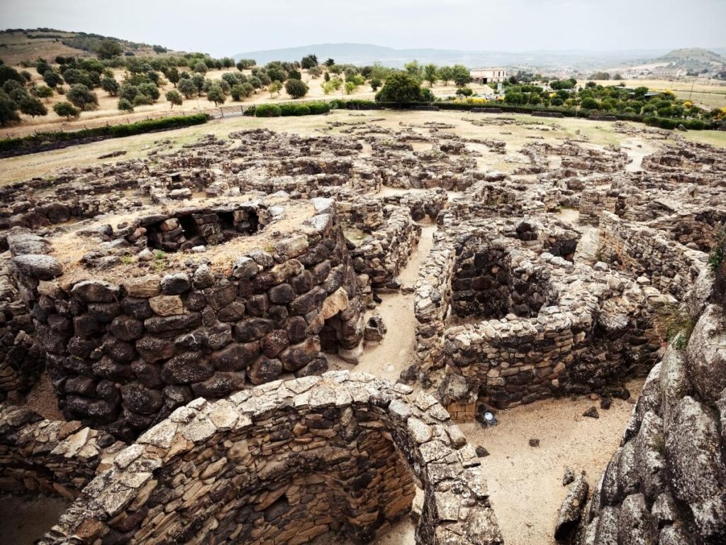 Stone towers and circular huts at Su Nuraxi di Barumini UNESCO site in Sardinia