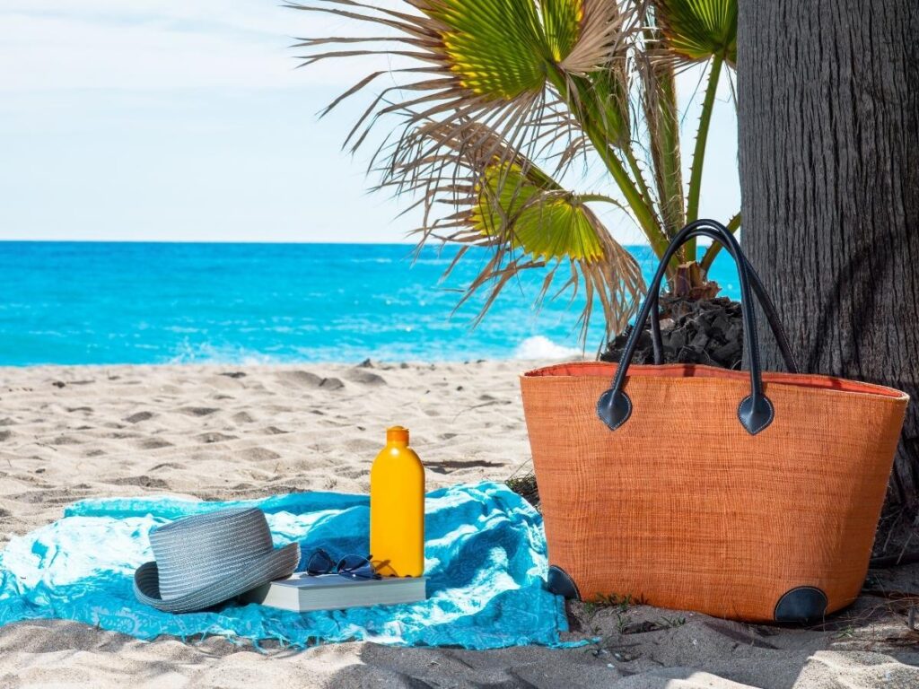 Reef-safe sunscreen on beach towel.