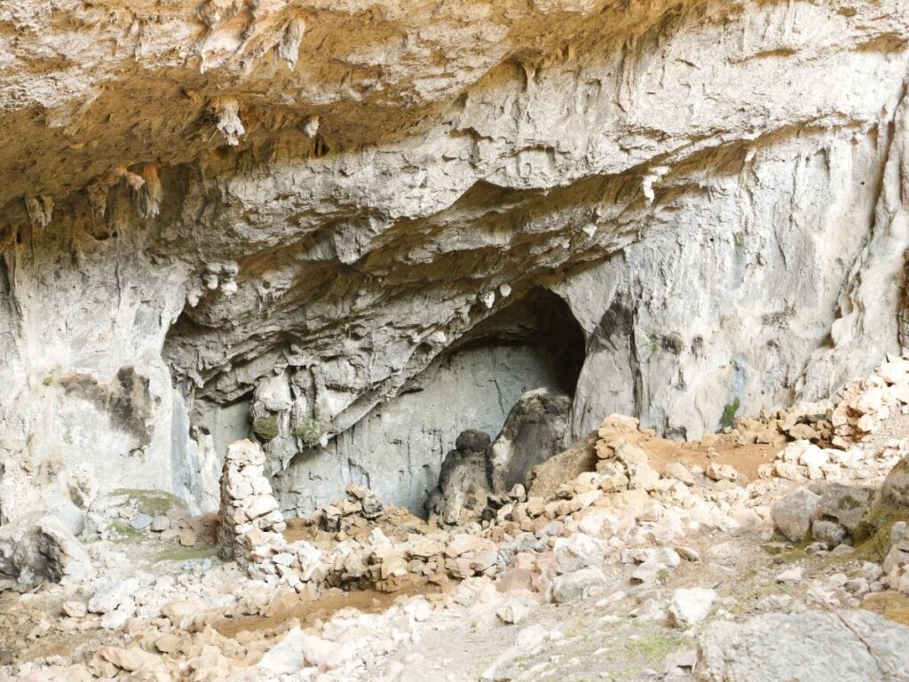 Ancient stone ruins of Tiscali Village hidden inside a collapsed cave in Sardinia’s Supramonte mountains