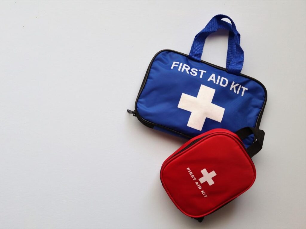 Compact travel first aid kit with medications and band-aids.