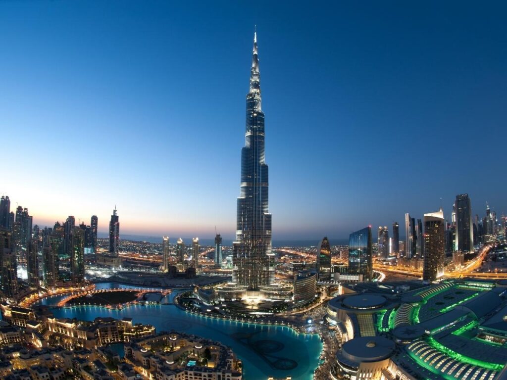 Dubai skyline with Burj Khalifa and Dubai Fountain show at dusk.