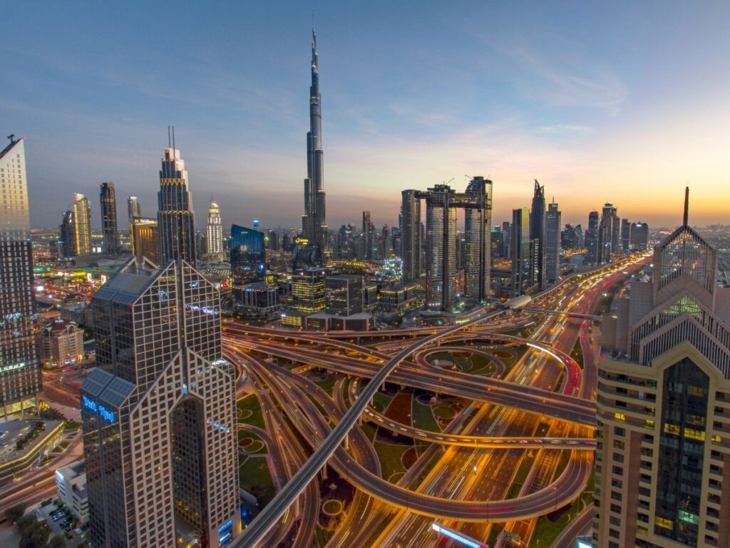 Modern skyline of Dubai with golden light and Burj Khalifa in the distance