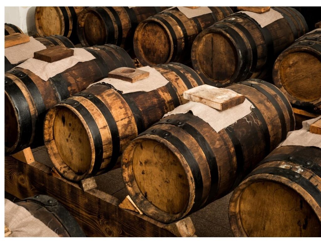 Wooden barrels filled with traditional balsamic vinegar inside a Modena acetaia