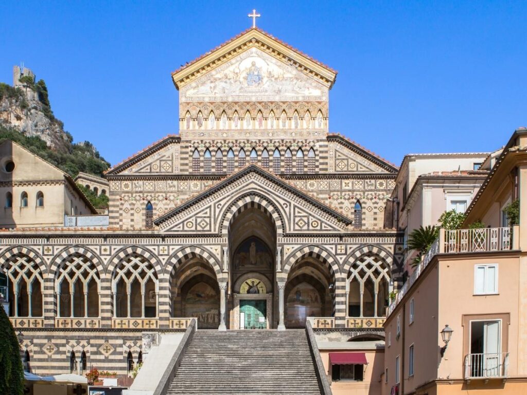 Tourists climbing the grand staircase of Amalfi Cathedral.