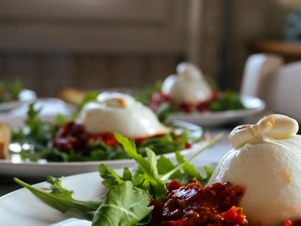 Pinterest pin showing Apulia food guide with burrata and orecchiette pasta.