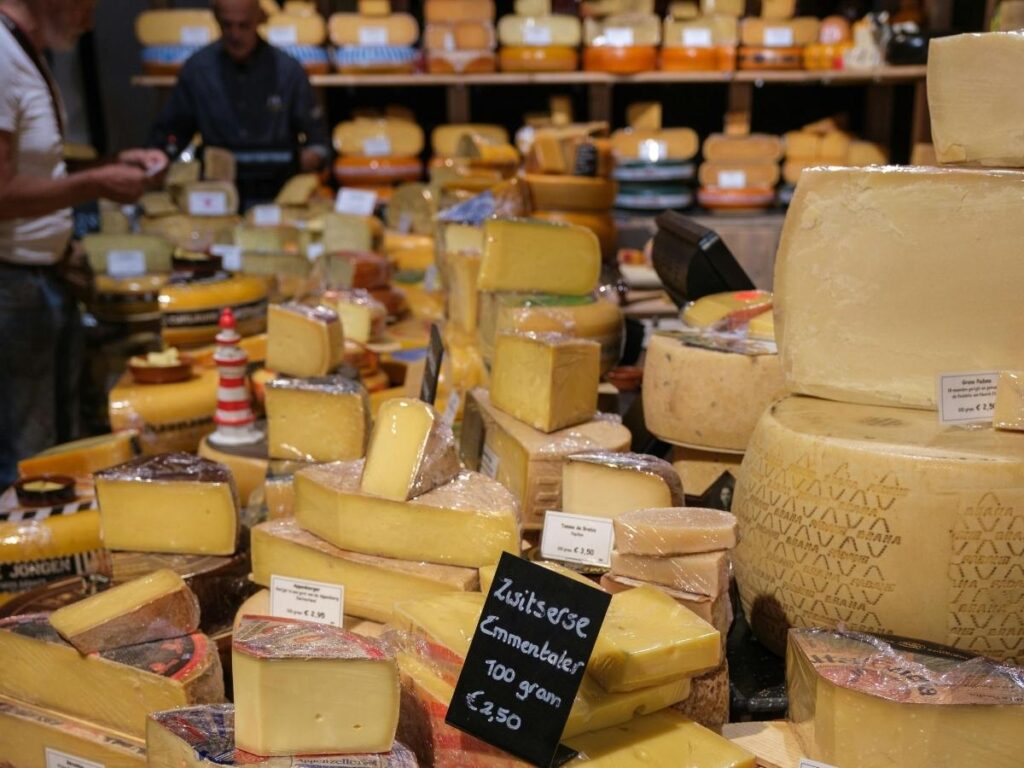 Stall selling salami, cheeses and jars of honey at Asti food market