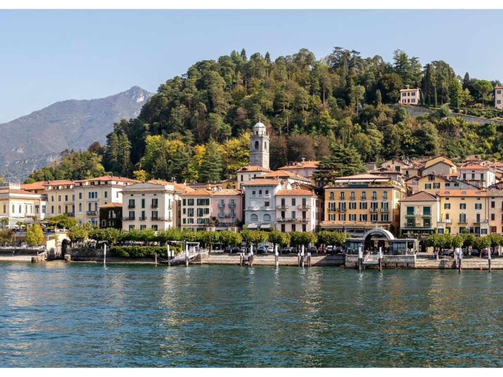 Bellagio lakeside promenade at golden hour with reflections on the water.