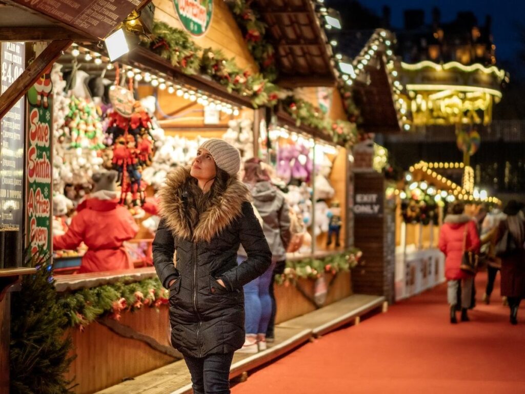 Christmas market stalls with festive lights in Piazza Maggiore, Bologna."