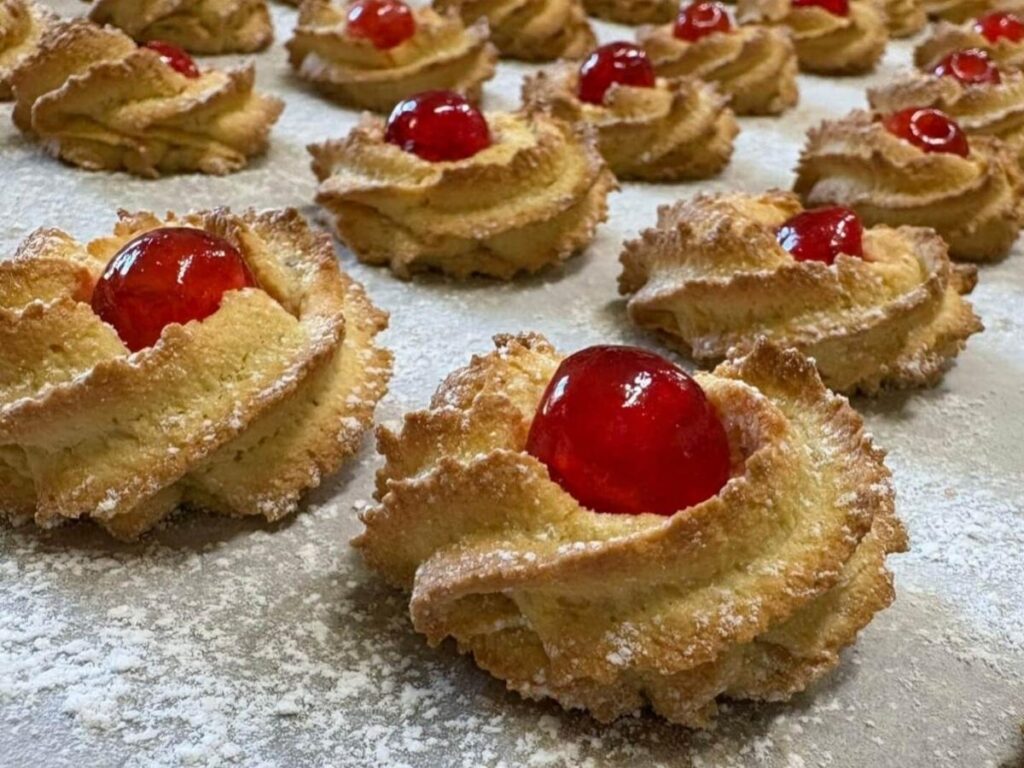 Tray of Calabrian dolci including zeppole, almond cookies, and ricotta pastries