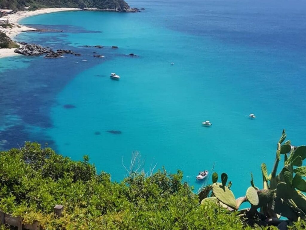 View from Belvedere Capo Vaticano looking over rugged coves and turquoise sea.