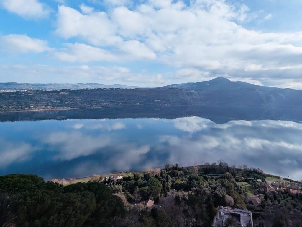 View from Castel Gandolfo down over Lake Albano and wooded crater rim.
