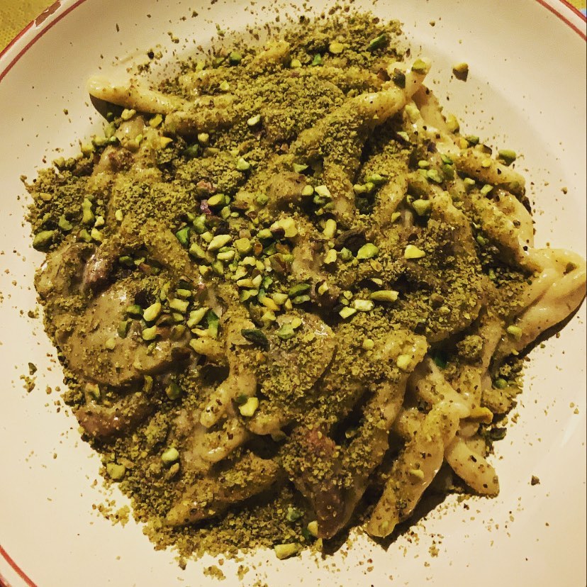 Traditional trattoria table set with pasta and wine in Ceglie Messapica.