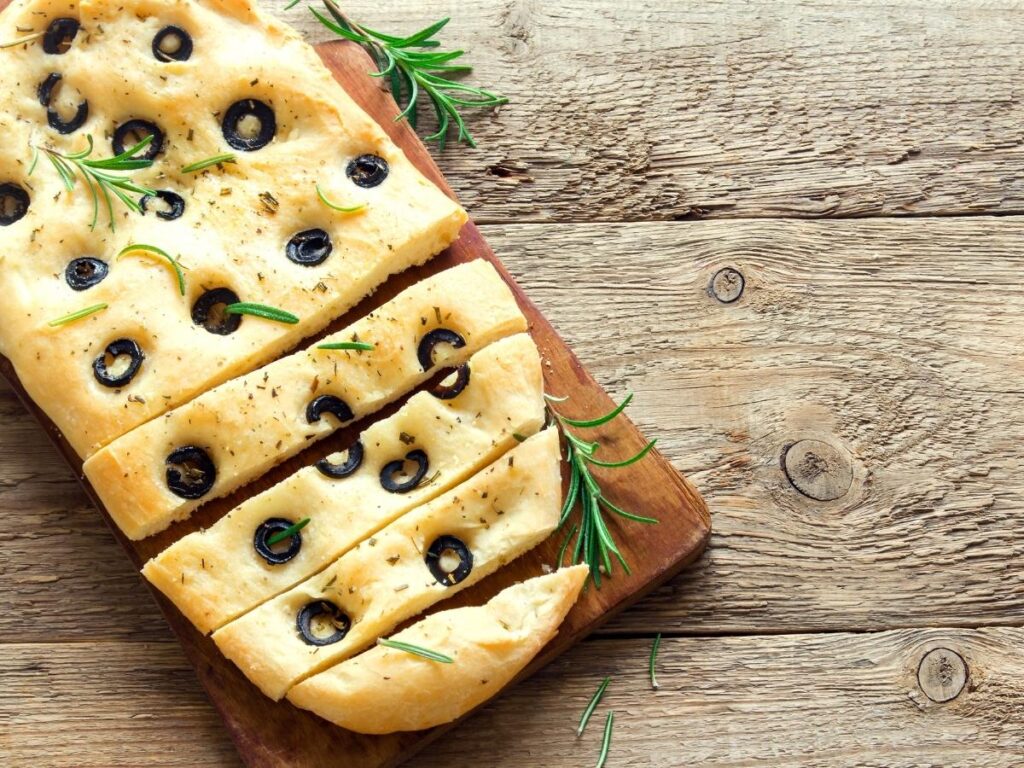 Collage of Ligurian food: focaccia, fried anchovies, and a small glass of Sciacchetrà.