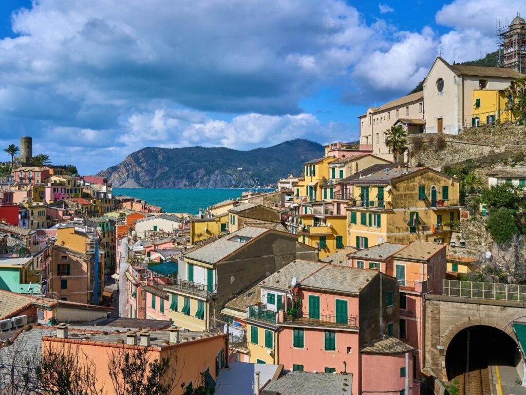 Colorful houses of Vernazza in Cinque Terre perched on cliffs by the sea.