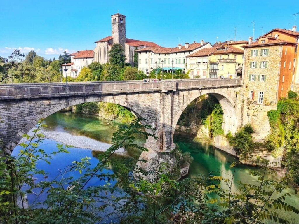 The Devil’s Bridge in Cividale del Friuli arching over the Natisone River with cobbled streets nearby