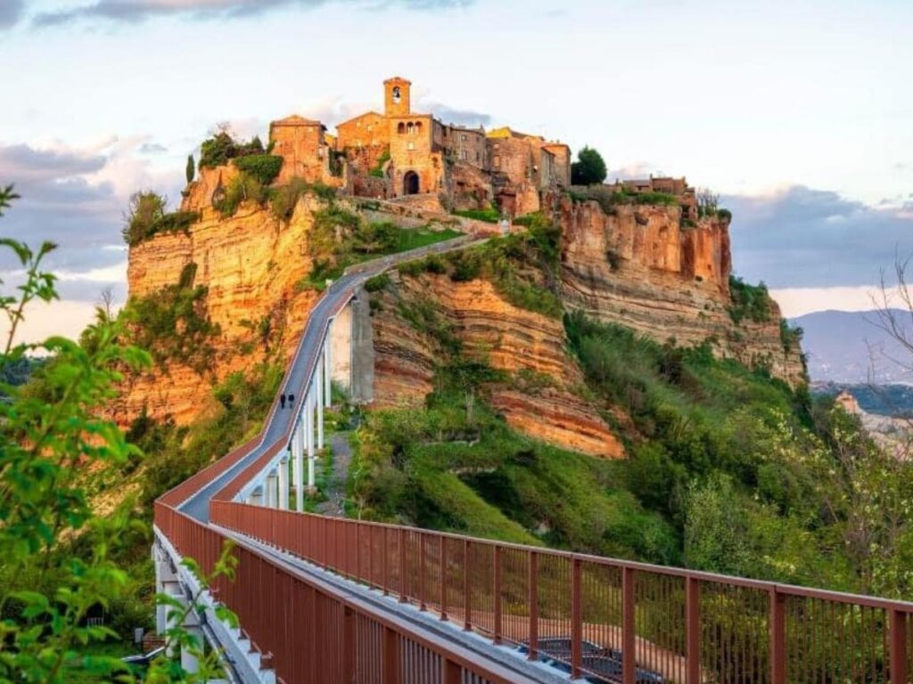 Civita di Bagnoregio from the valley with footbridge at golden hour