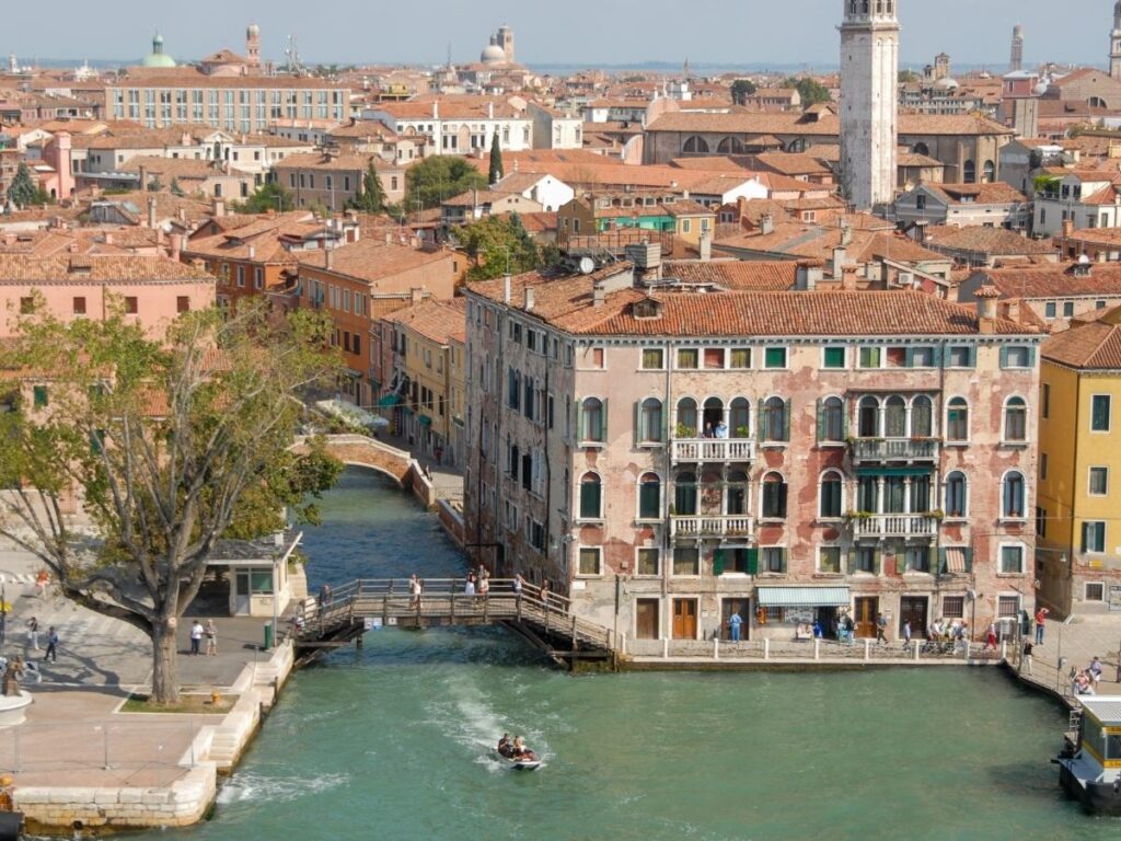 Locals strolling along the Zattere promenade in Dorsoduro at sunset.