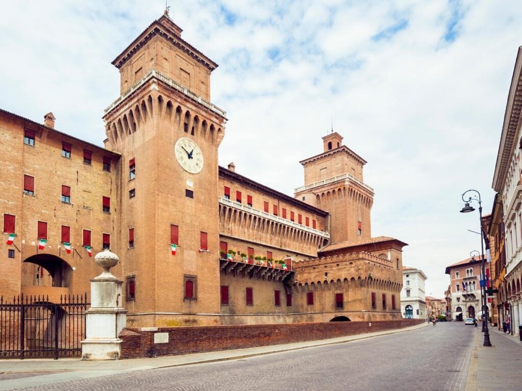 Cyclists riding along Ferrara’s Renaissance city walls on a sunny day.