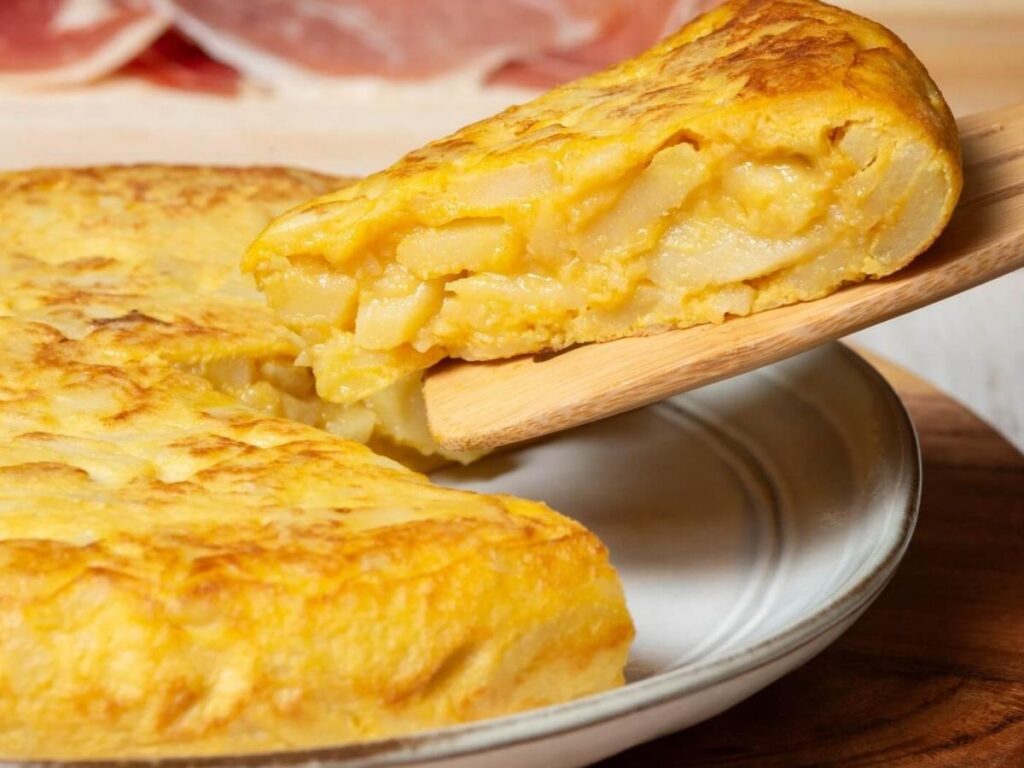 Crispy frico served on a plate in a mountain hut with wooden interior visible