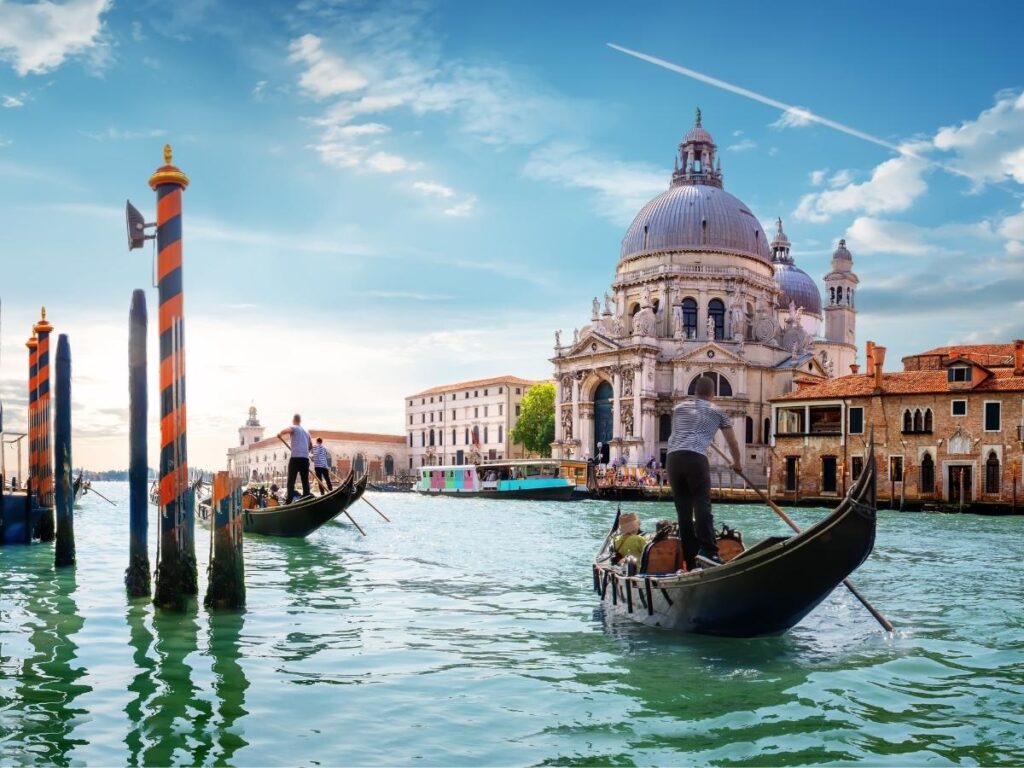 View of Venice skyline from Giudecca island with boats crossing the lagoon