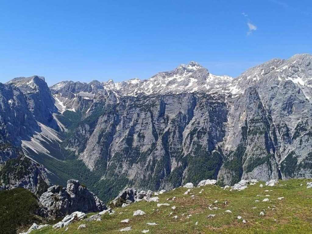 “Panoramic view from a trail in the Julian Alps showing ridgelines and distant peaks